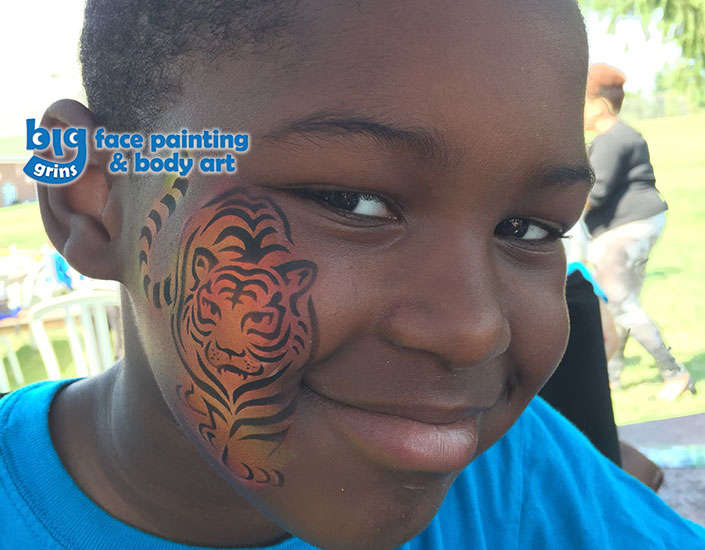 big grins airbrush face painting of tiger on boy's face