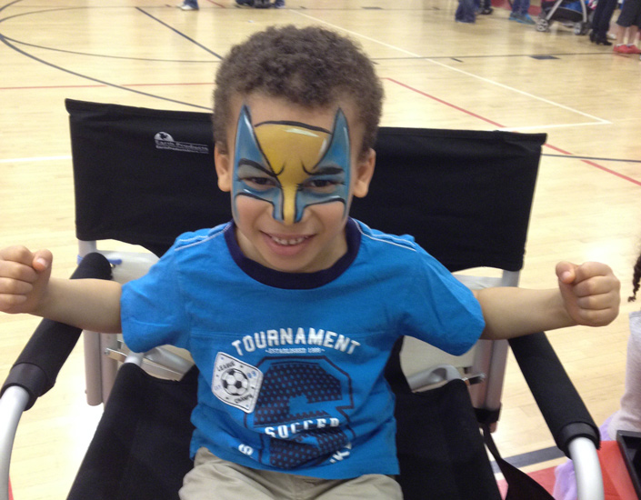 kid face painted as a super hero